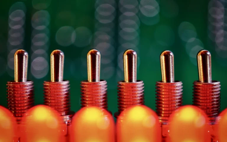 Close view of a populated circuit board showing capacitors, resistors and solder joints