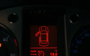 Several warning lights lit at the same time on a vehicle instrument panel at night