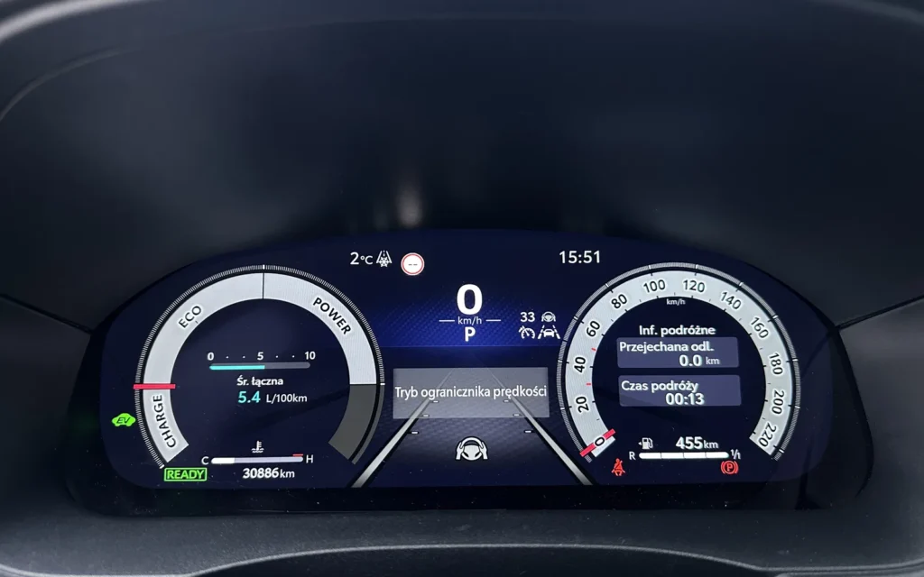 A fully digital instrument cluster displaying speed, drive mode and hybrid system status