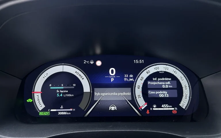 A fully digital instrument cluster displaying speed, drive mode and hybrid system status